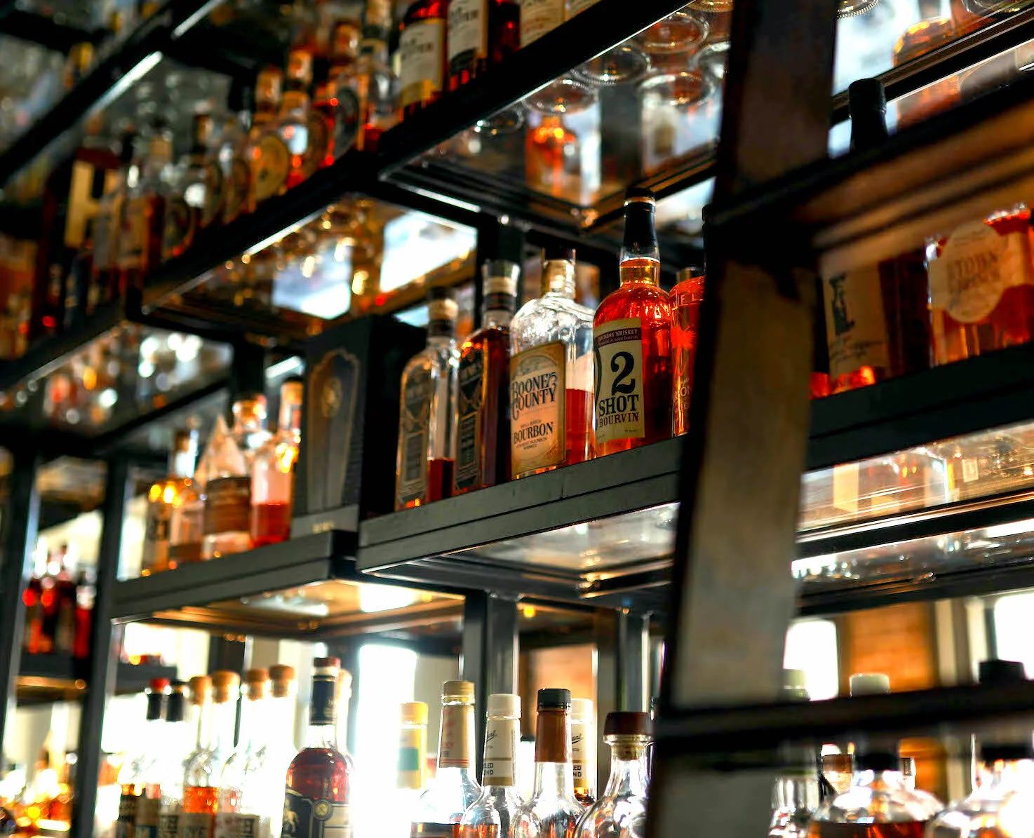 The bourbon wall behind the main bar at Smoke Justis